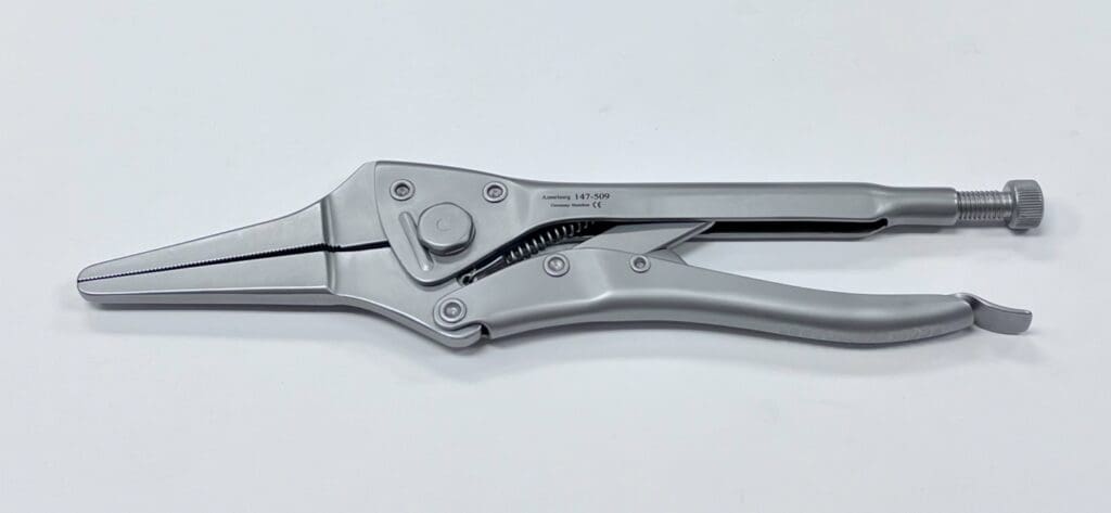 A silver locking pliers and needle nose pliers on a white surface.