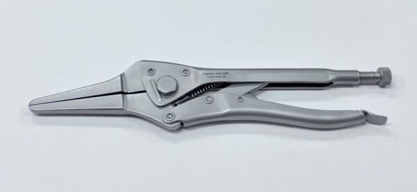 A silver locking pliers and needle nose pliers on a white surface.