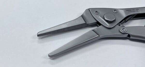 A pair of LOCKING PLIERS, NEEDLE NOSE on a white surface.
