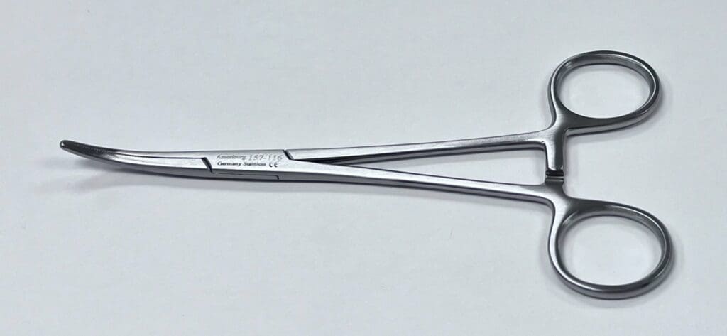 A pair of tweezers on a white surface.
