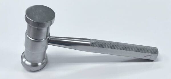 An orthopedic mallet on a white surface.