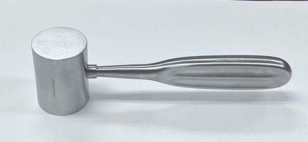 A silver metal handle on a white surface.