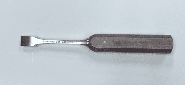 A small LEXER CHISEL with a handle on a white surface.