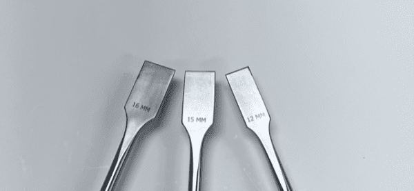 Three LEXER CHISEL tools on a white surface.