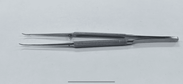 A pair of MICRO TISSUE FORCEP on a white surface.