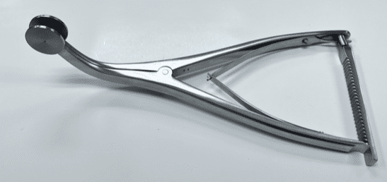 A femoral-tibial spreader on a white surface.