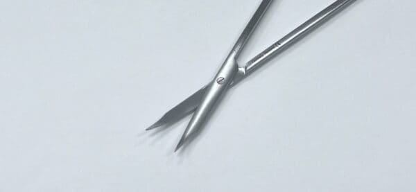 A pair of POTTS TENOTOMY SCISSORS on a white surface.