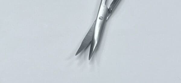 A pair of JAMISON-REYNOLDS DISSECTING SCISSORS on a white surface.