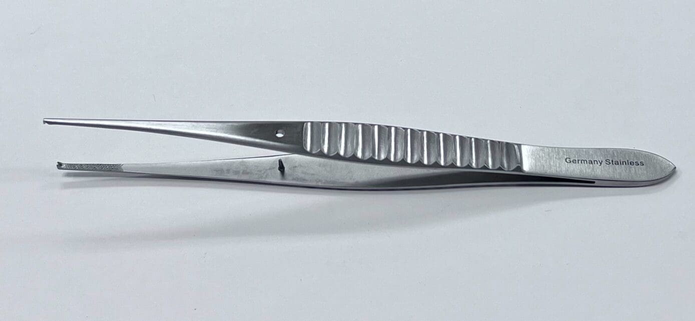 A pair of GILLIES TISSUE FORCEP tweezers on a white surface.