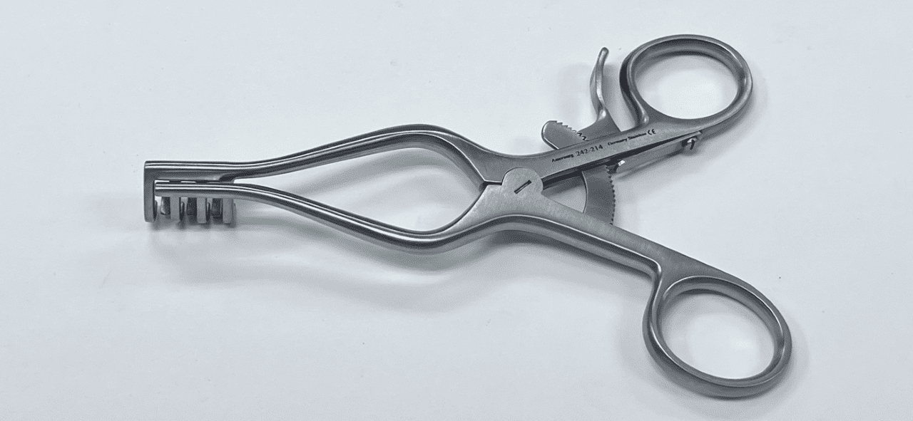 A WEITLANER RETRACTOR, BLUNT PRONGS on a white surface.