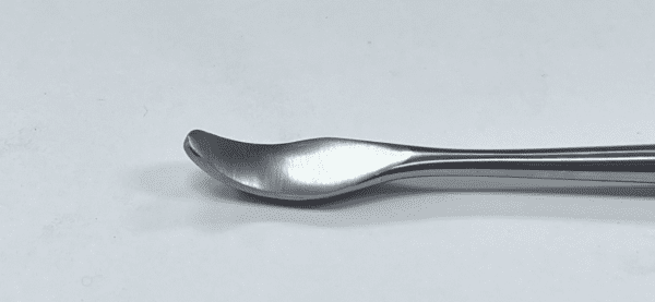A CHANDLER ELEVATOR spoon on a white surface.