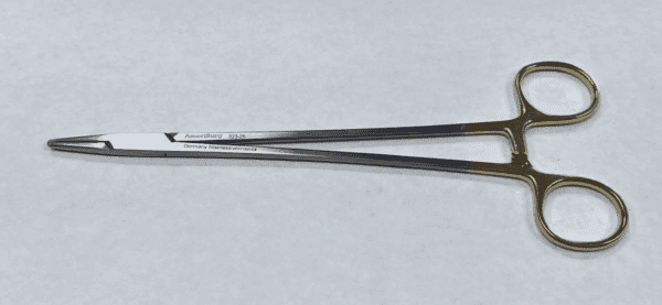 A TC CRILE WOOD NEEDLE HOLDER on a white surface.