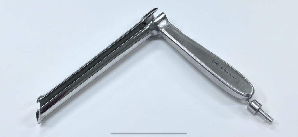 A Carlen Type Mediastinoscope on a white surface.