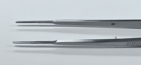 A Gerald Tissue Forcep on a white surface.