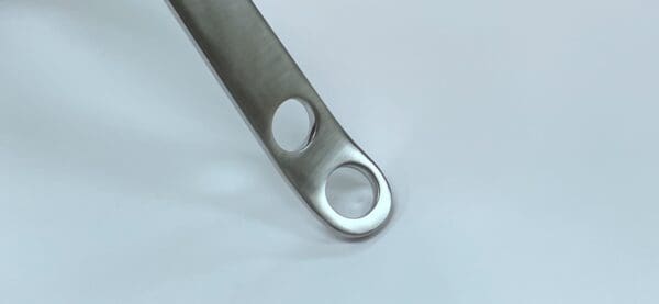 A HOHMANN RETRACTOR, SHORT 90d stainless steel tool with a hole in it.