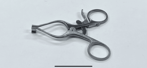 A Wilson Type Trigger Finger Retractor on a white surface.