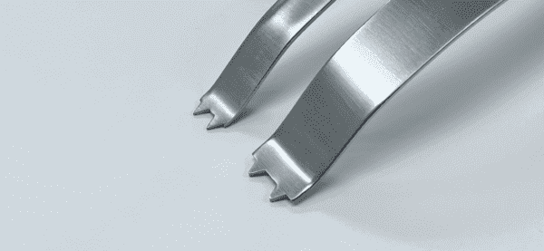 A pair of THIN GLENOID RETRACTOR forks on a white surface.
