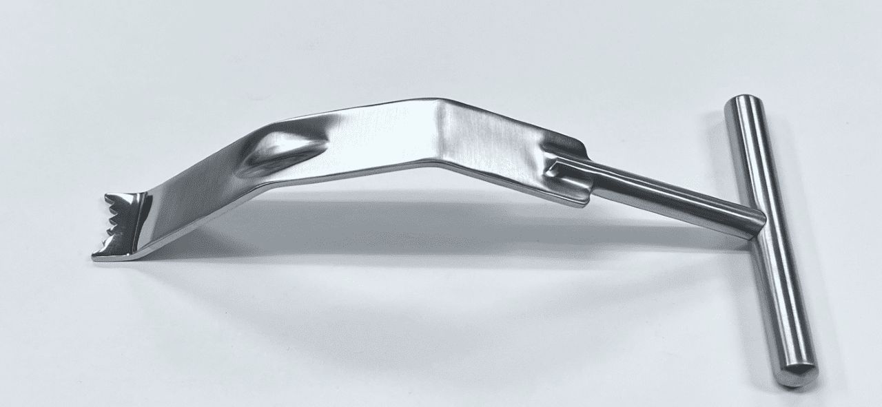 A FUKUDA RETRACTOR, MODIFIED, EVANS TYPE handle on a white surface.