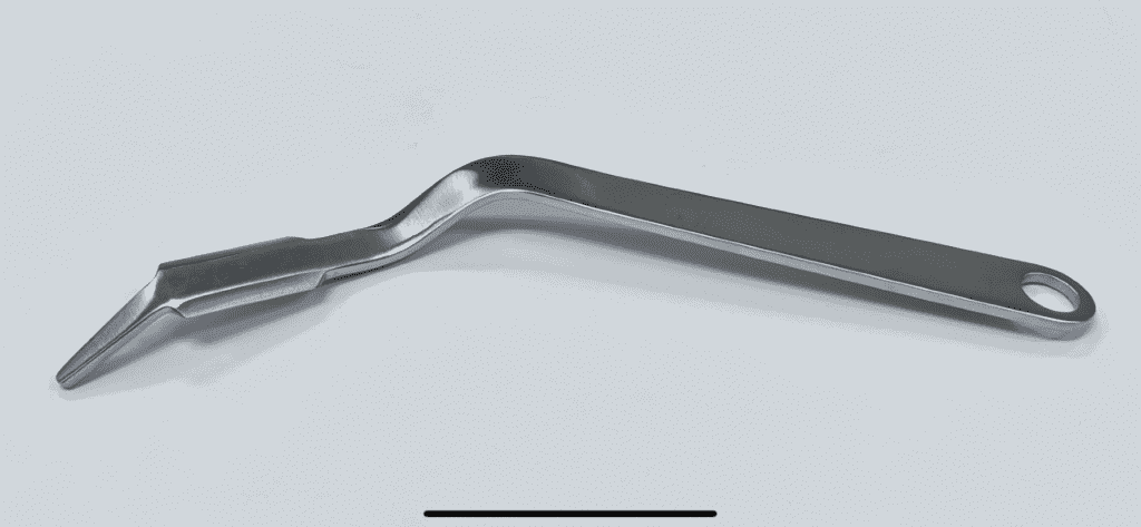 A PENENBERG TYPE GLUTEUS RETRACTOR handle on a white surface.