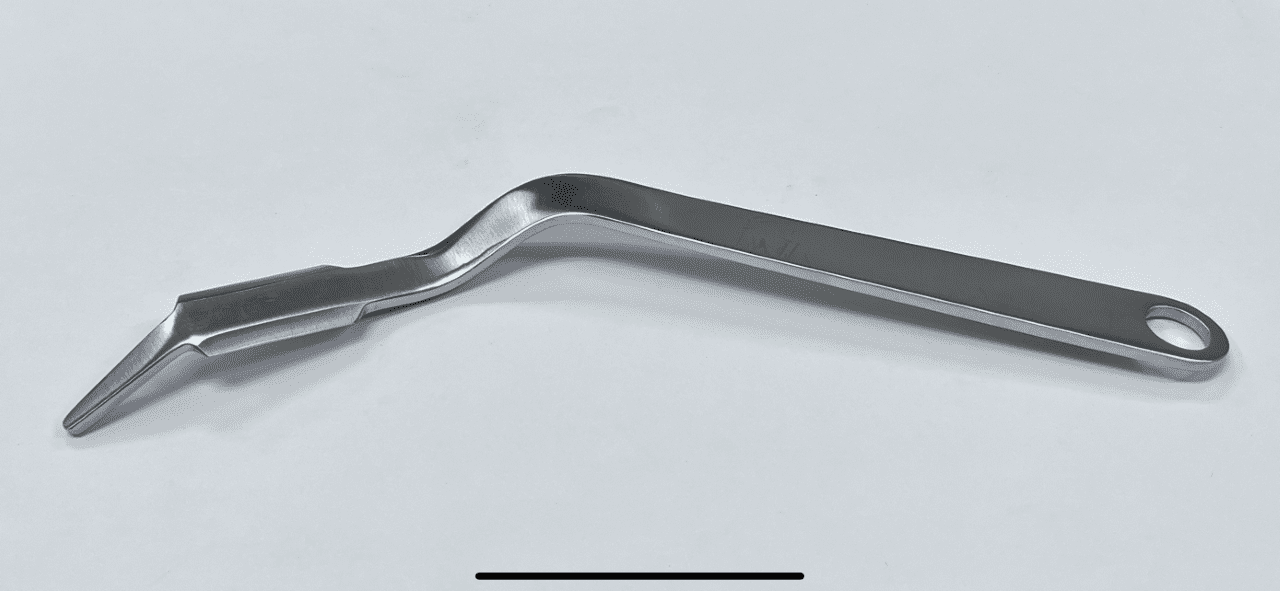 A PENENBERG TYPE GLUTEUS RETRACTOR handle on a white surface.