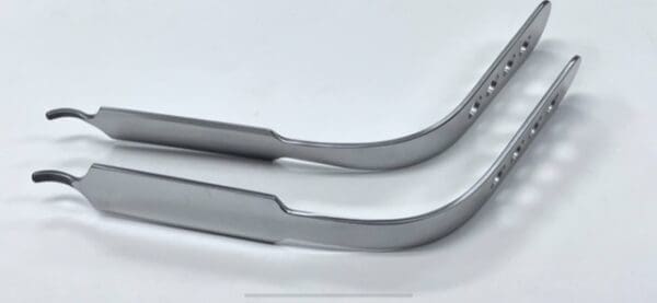 A pair of INFERIOR RETRACTOR, DUKE TYPE handles on a white surface.