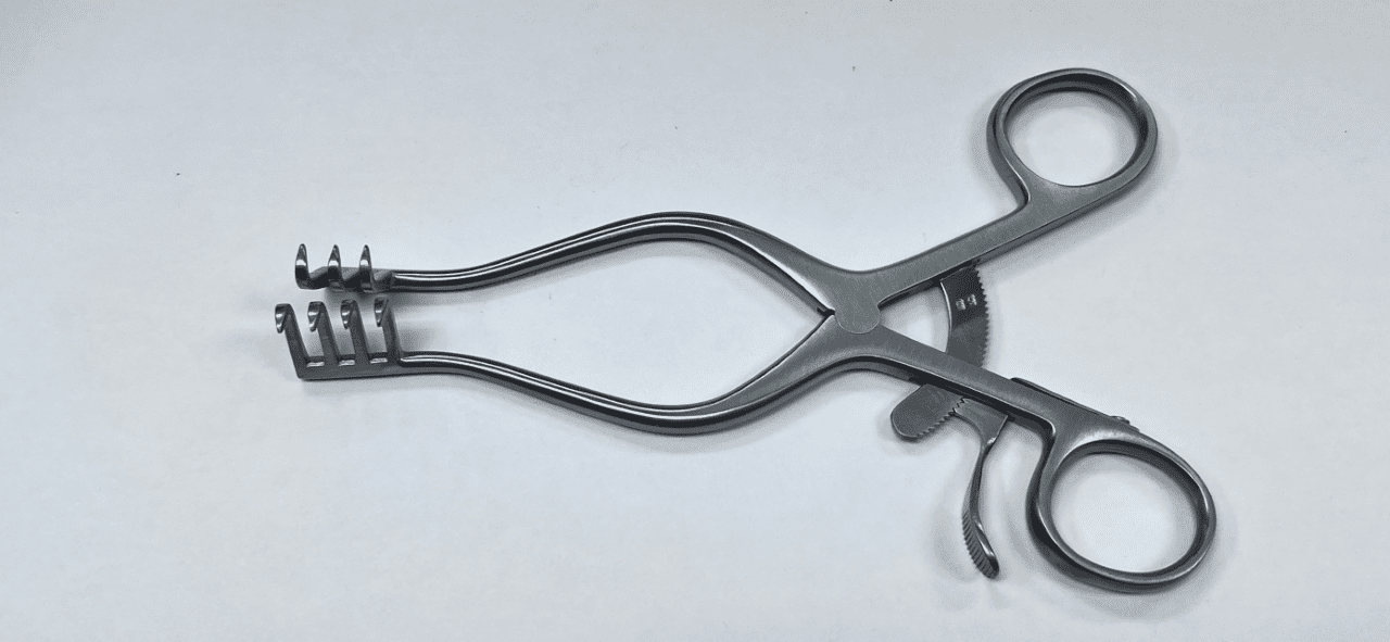 A WEITLANER RETRACTOR, SHARP PRONGS on a white surface.