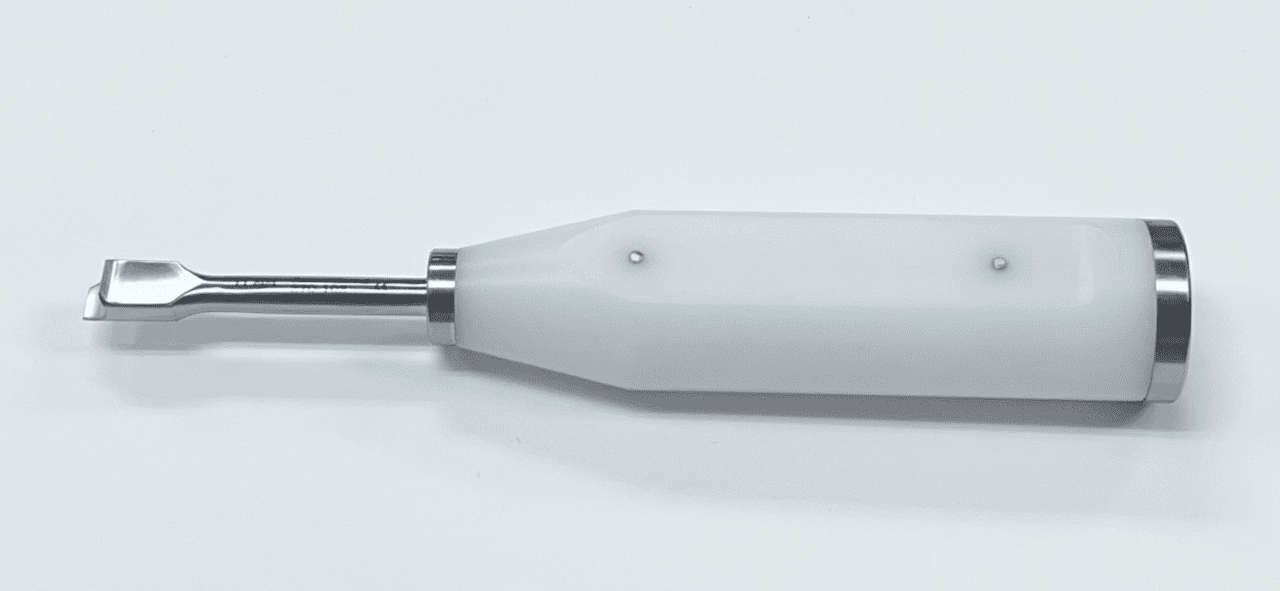 A MORELAND TYPE FEMORAL/TIBIAL EXTRACTOR with a metal handle on a white surface.