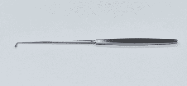 A MCCULLOUGH BALL PROBE with a long handle on a white surface.