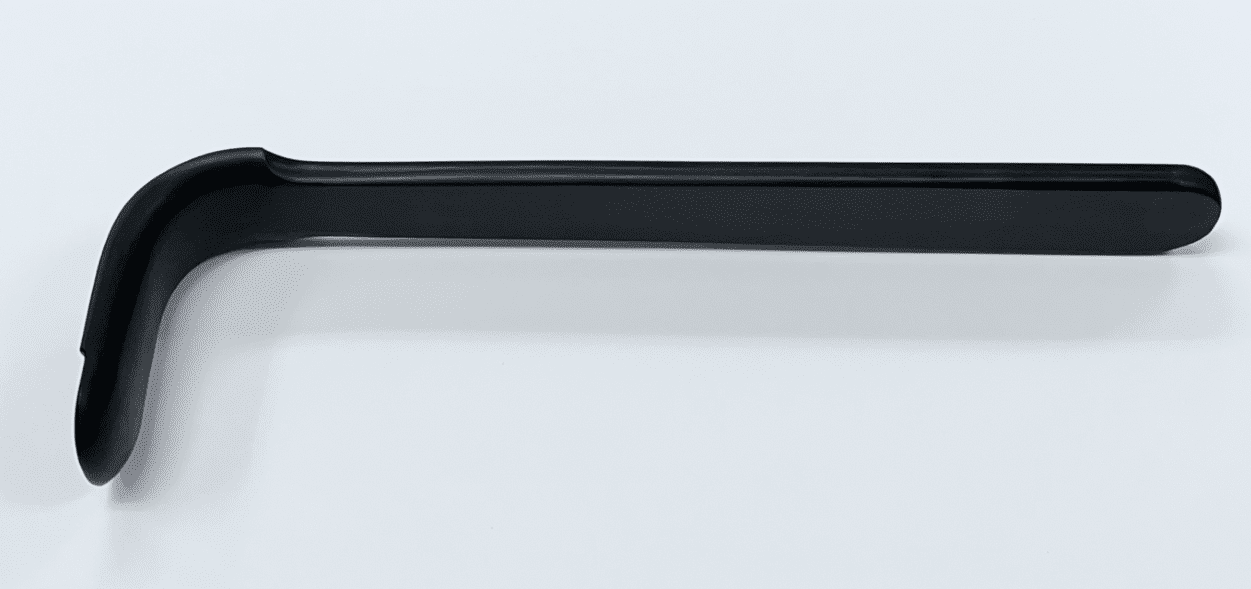 A black BROWN DELTOID RETRACTOR, RADIOLUCENT, MODIFIED handle on a white surface.