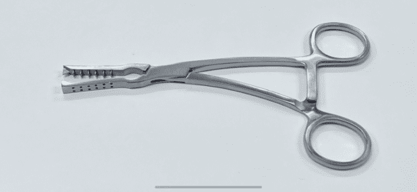 A pair of meniscal clamps on a white surface.