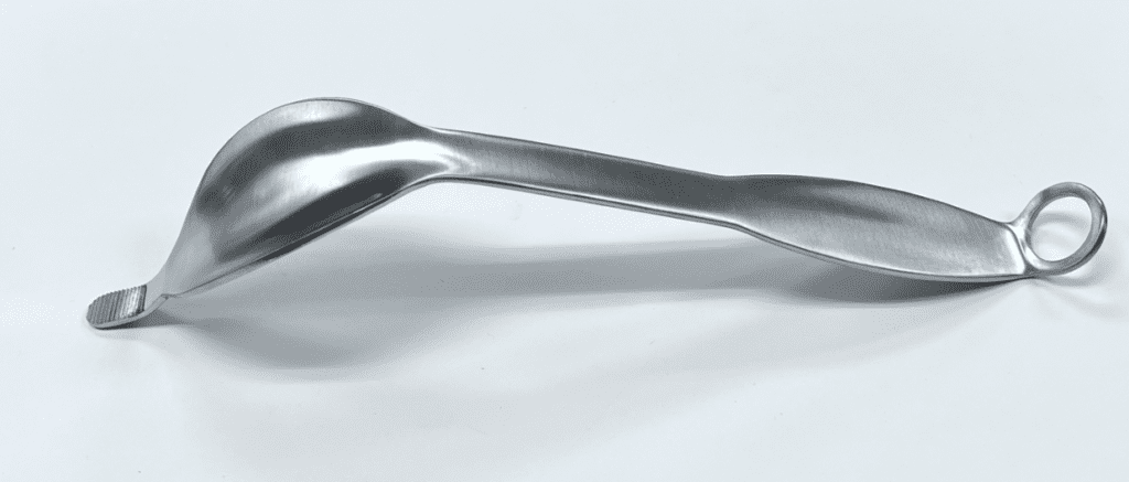 A COBRA RETRACTOR, WIDE on a white surface.