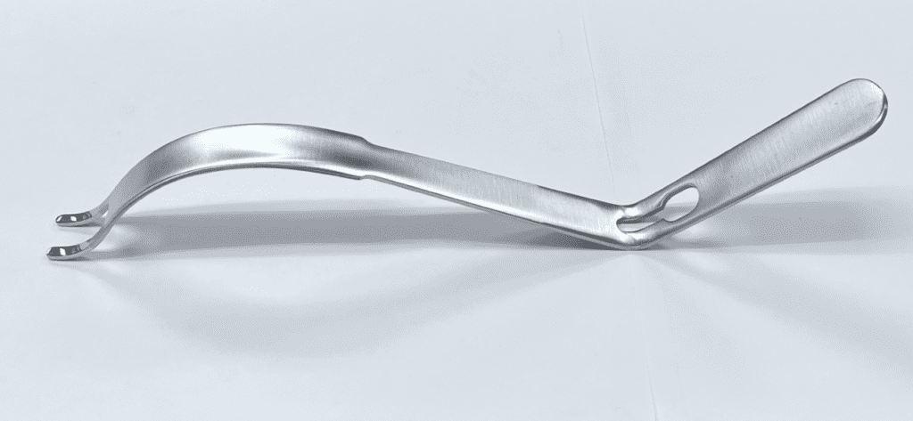 A silver metal handle on a white surface of the APC TYPE HIP RETRACTOR, DOUBLE PRONG.