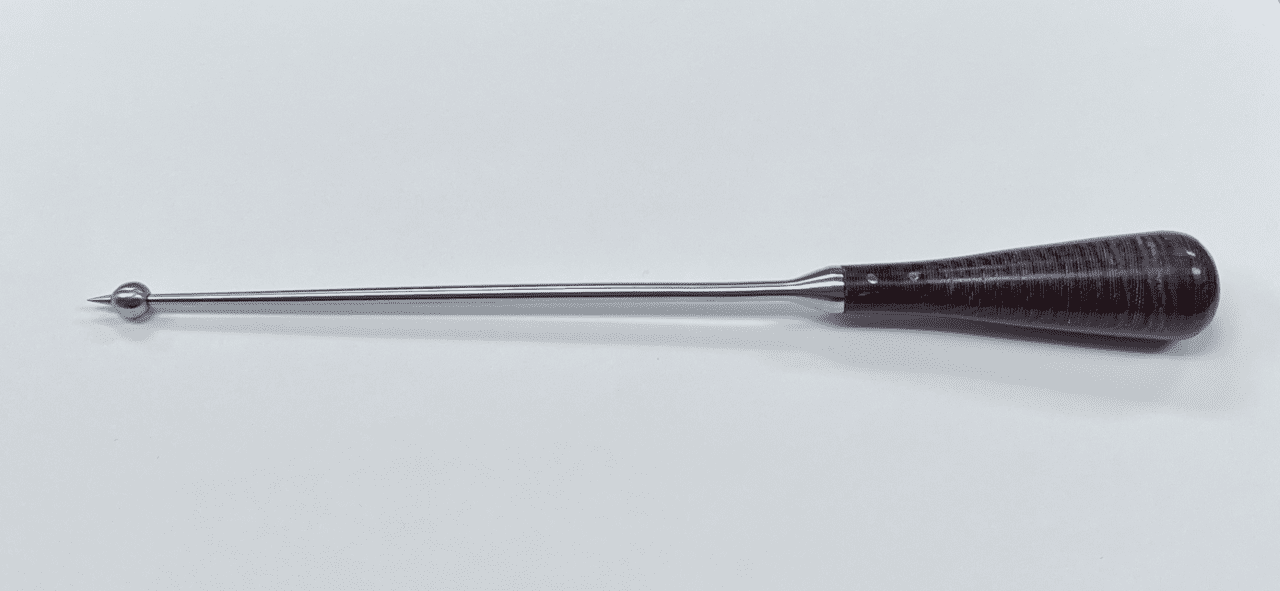A black and silver BALL SPIKE WITH BELL HANDLE on a white surface.