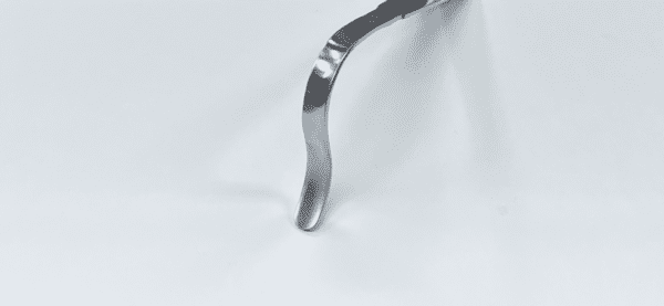A MIS Knee Condylar Retractor on a white surface.