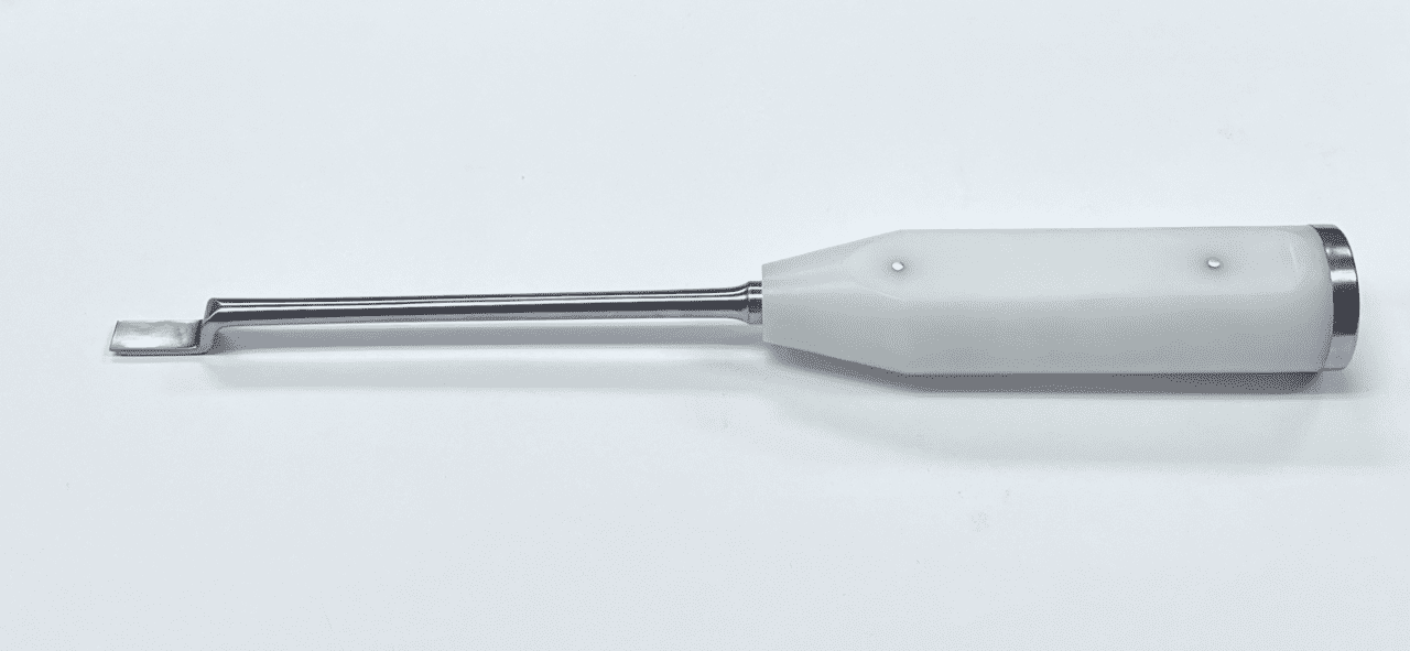 A white MUELLER OFFSET CHISEL with a metal handle on a white surface.
