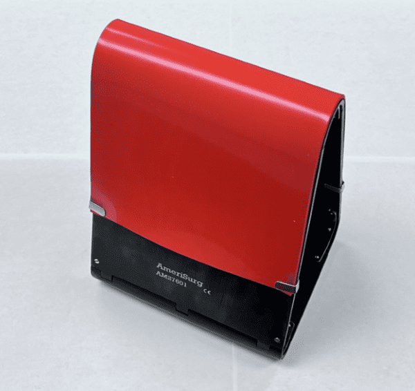 A red and black ORTHOPEDIC KNEE POSITIONING TRIANGLES holder sitting on a tile floor.