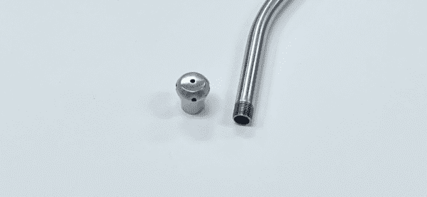 A Yankauer suction tube and a metal rod on a white surface.