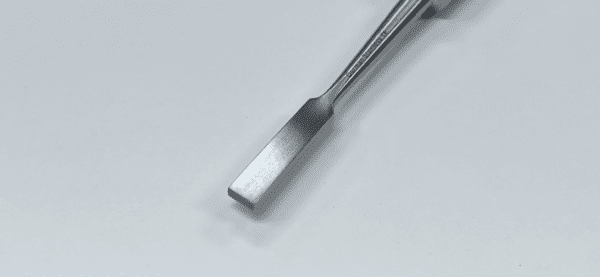 A MOE IMPACTOR tool with a handle on a white surface.