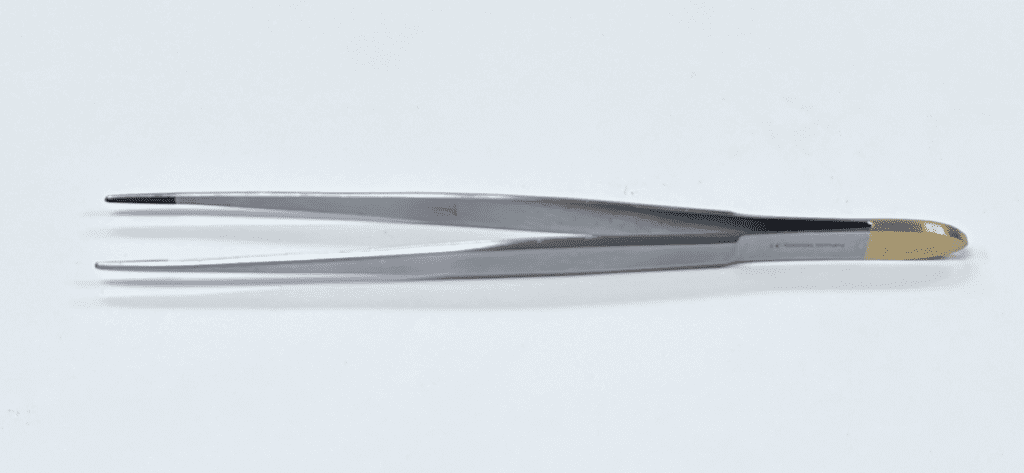 A pair of TC CUSHING TISSUE FORCEP tweezers on a white surface.