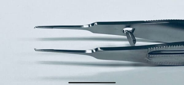 A pair of STERN-CASTROVIEJO SUTURE FORCEP on a white surface.