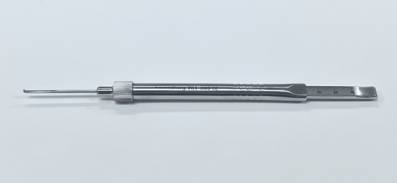 A large screw depth gauge with a metal handle on a white surface.