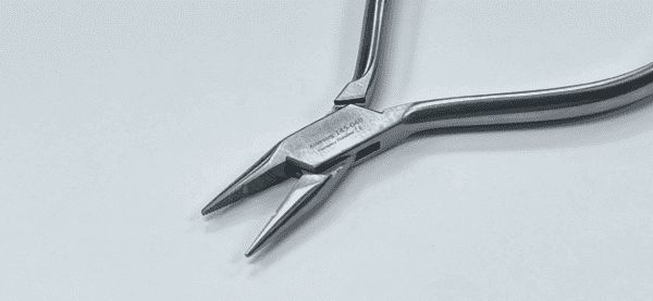 A pair of needle nose pliers on a white surface.