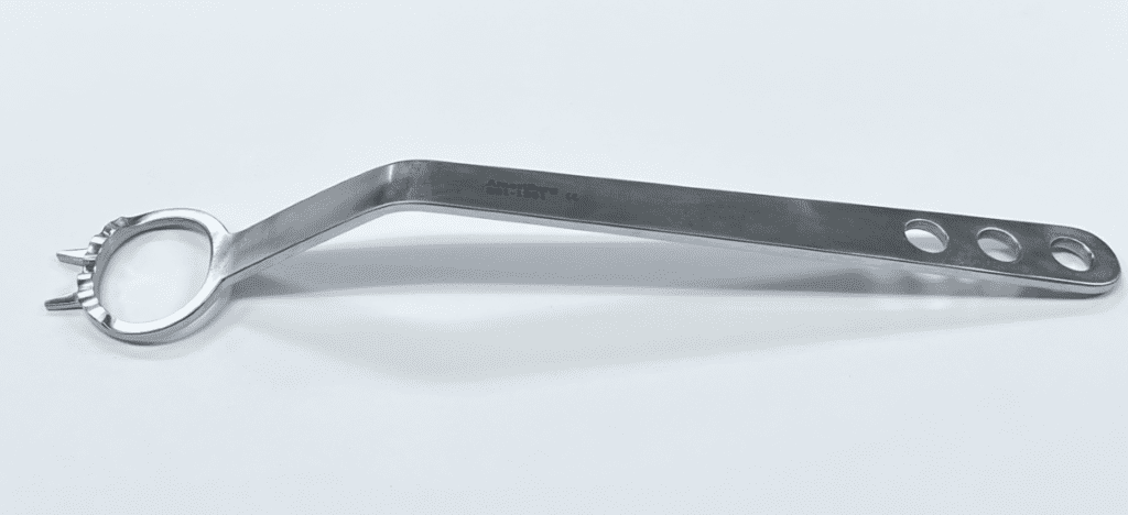 A stainless steel Glenoid Access Retractor with holes on a white surface.