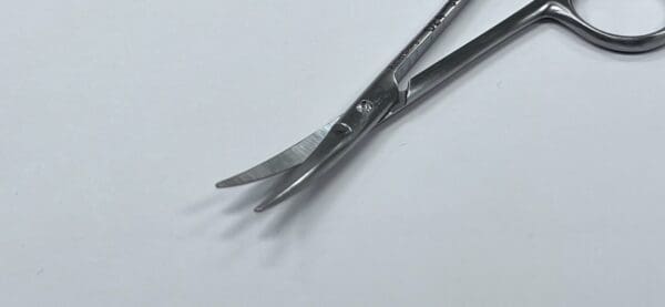 A pair of UTILITY SCISSORS on a white surface.