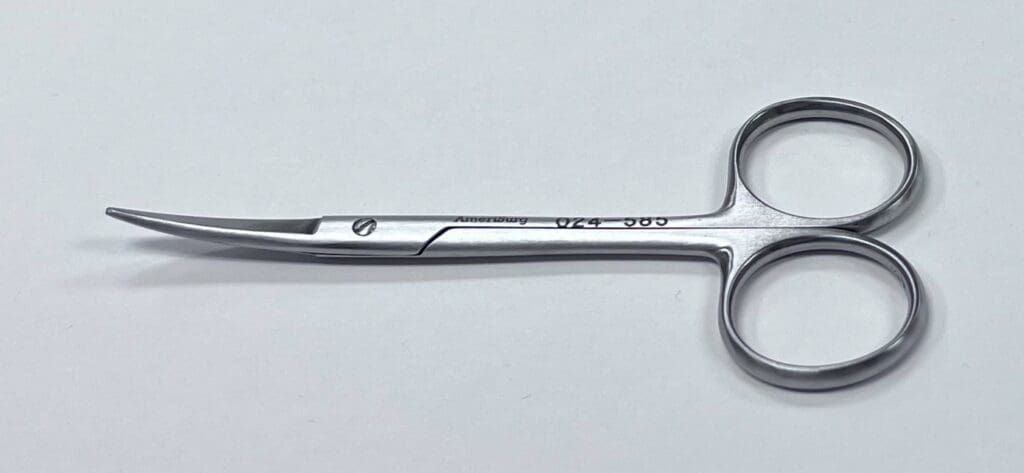 A UTILITY SCISSOR on a white surface.