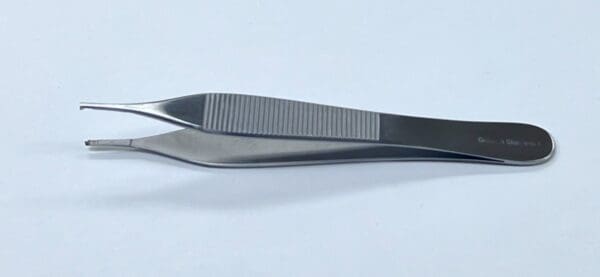 A pair of CALLISON ADSON TISSUE AND TYING FORCEP tweezers on a white surface.