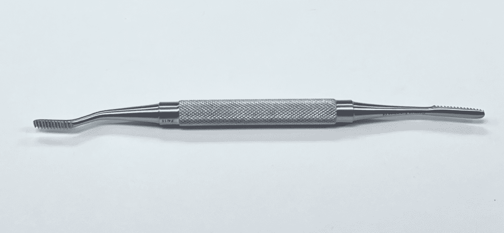 A Miller Bone File with a handle on a white surface.