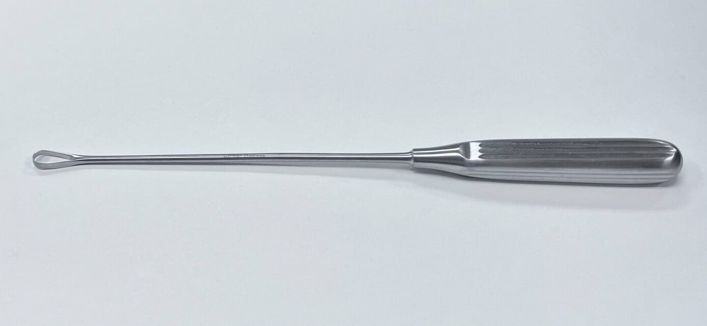A THOMAS UTERINE CURETTE on a white surface.