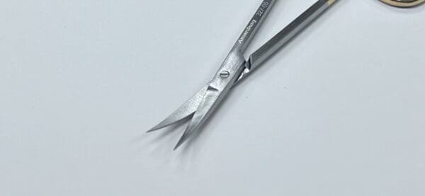 A pair of TC IRIS SCISSORS on a white surface.