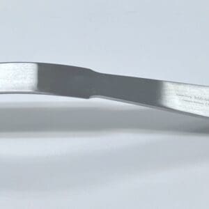 A SOFT TISSUE RETRACTOR, SINGLE PRONG handle on a white surface.